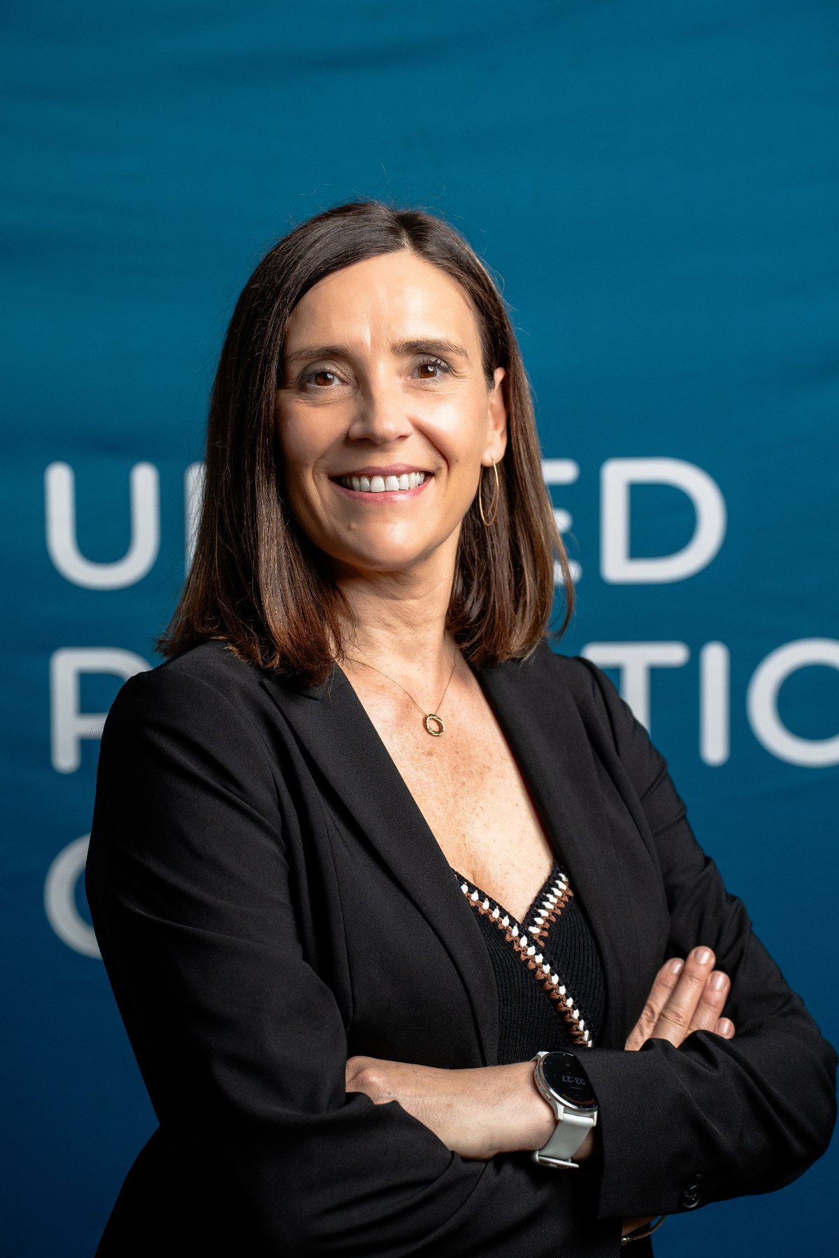 Kerstin Wagner, Co-CEO and COO of United Robotics Group, in front of the company logo.